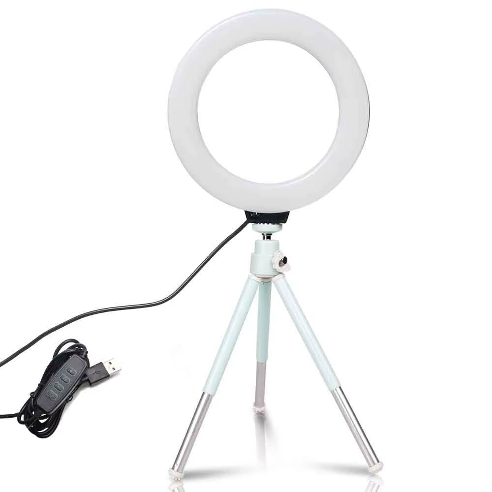 The 6 - inch mini LED desktop video ring light with a tripod stand and USB plug is a versatile lighting tool for live photo photography in a studio setting. - Dymand