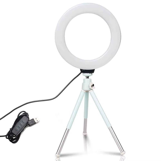 The 6 - inch mini LED desktop video ring light with a tripod stand and USB plug is a versatile lighting tool for live photo photography in a studio setting. - Dymand