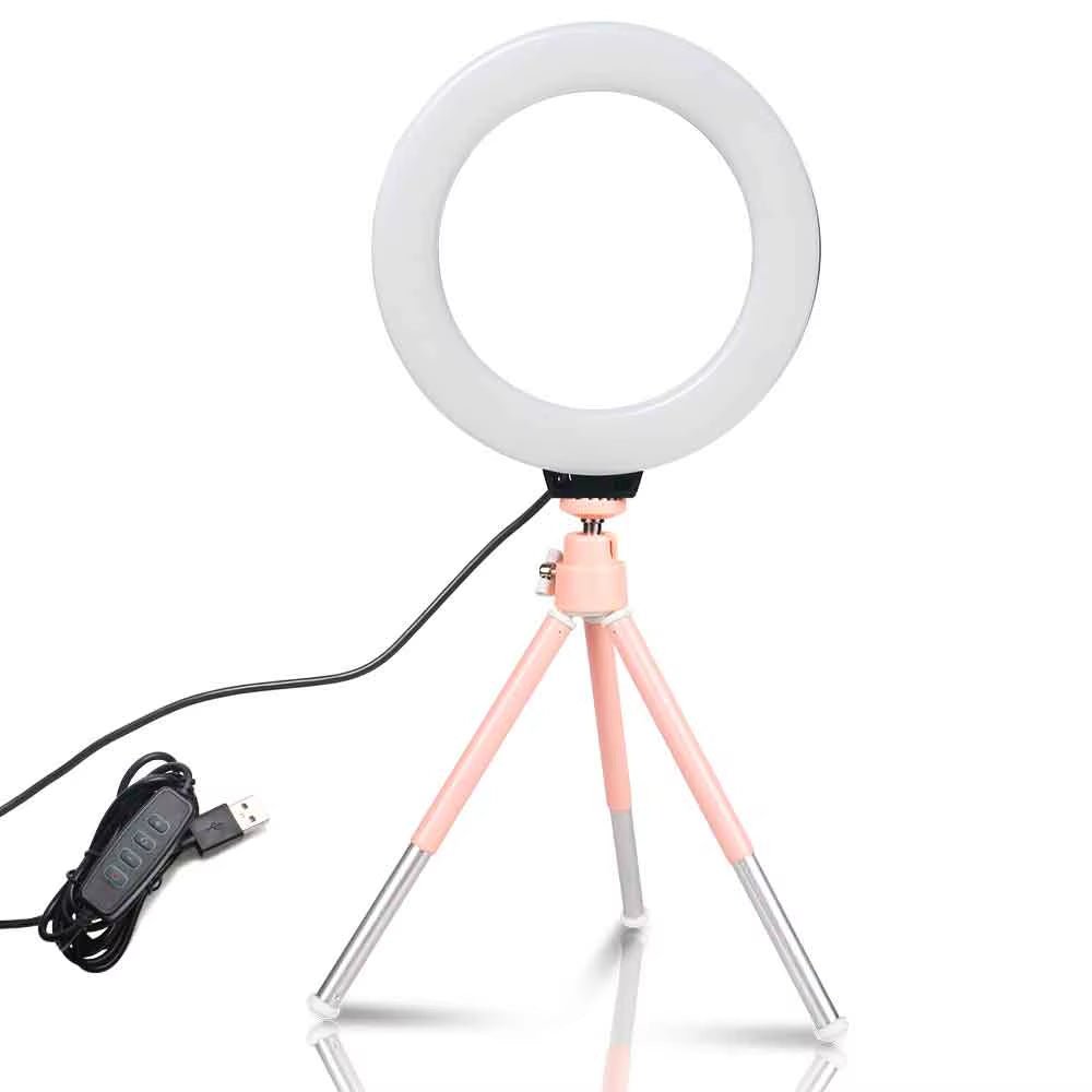 The 6 - inch mini LED desktop video ring light with a tripod stand and USB plug is a versatile lighting tool for live photo photography in a studio setting. - Dymand