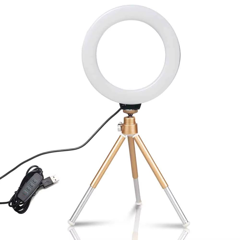 The 6 - inch mini LED desktop video ring light with a tripod stand and USB plug is a versatile lighting tool for live photo photography in a studio setting. - Dymand