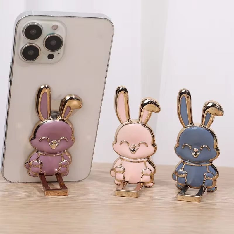 The finger ring phone holder is a compact and lightweight desktop accessory that features a cartoon rabbit design. - Dymand