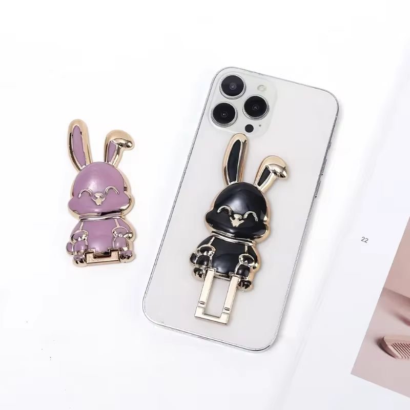 The finger ring phone holder is a compact and lightweight desktop accessory that features a cartoon rabbit design. - Dymand