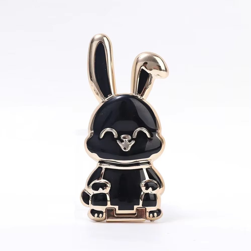 The finger ring phone holder is a compact and lightweight desktop accessory that features a cartoon rabbit design. - Dymand