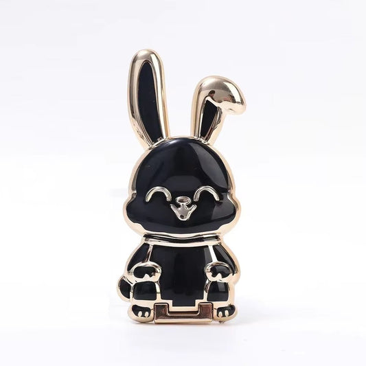 The finger ring phone holder is a compact and lightweight desktop accessory that features a cartoon rabbit design. - Dymand