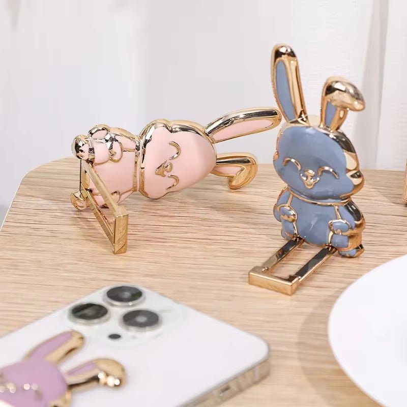 The finger ring phone holder is a compact and lightweight desktop accessory that features a cartoon rabbit design. - Dymand