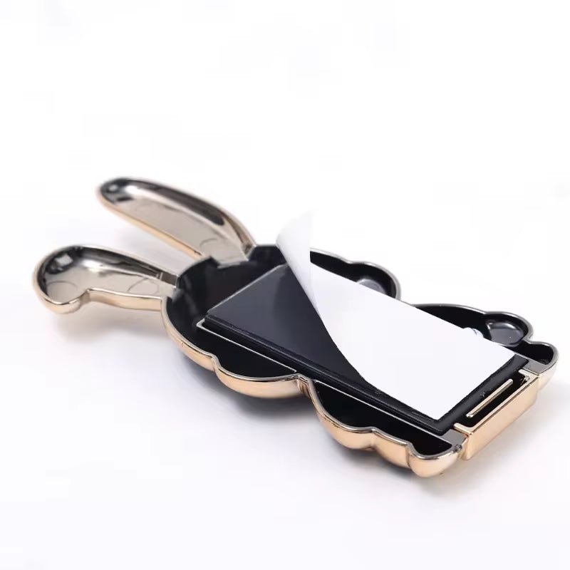 The finger ring phone holder is a compact and lightweight desktop accessory that features a cartoon rabbit design. - Dymand